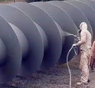 Man Spray Painting large metal screw